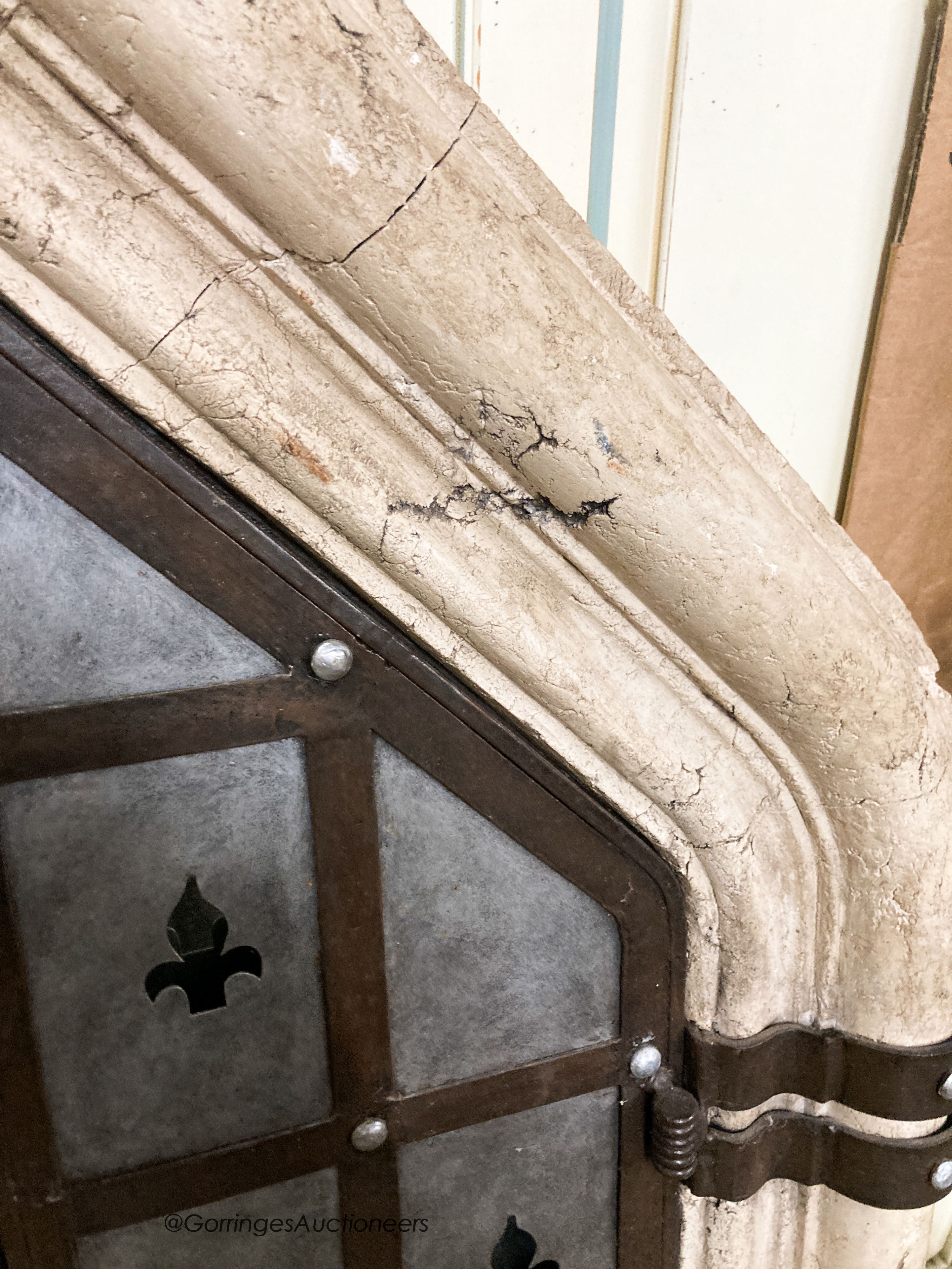 A medieval style simulated stone and wrought iron wall mirror, width 92cm, height 156cm